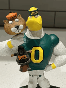 a figurine of an eagle and a squirrel with a hat that says osu