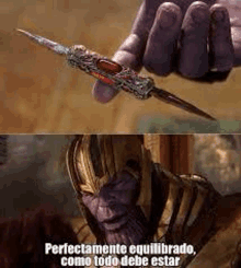 thanos is holding a knife in his hand .