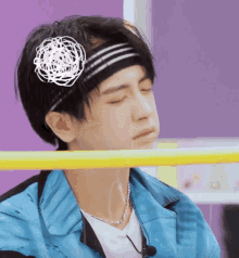 a man wearing a headband with a flower in it