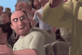 a bald man is sitting in a crowd of people and making a face