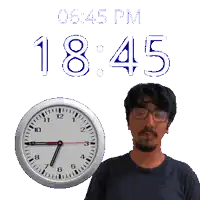 a man stands in front of a wall clock that says 1845
