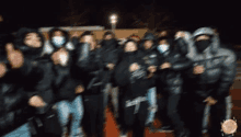 a blurry photo of a group of people wearing hoodies and masks