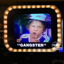 a vizio tv shows a young boy with the words " gangster " on the screen