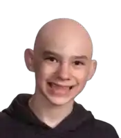 a young boy with a bald head is smiling