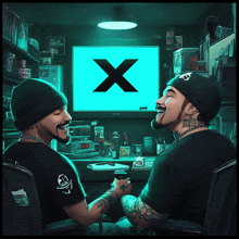 two men are sitting in front of a computer screen with a blue x on it