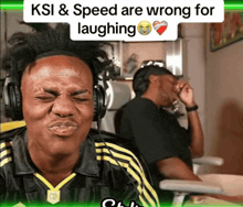 a man wearing headphones is laughing with the words ksi & speed are wrong for laughing behind him