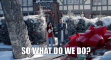 a man and woman standing next to a car with a red bow and the words so what do we do