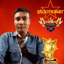 a man wearing ear buds stands in front of a starmaker advertisement