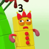 a yellow block with a red crown on its head and a number 3 on its head .