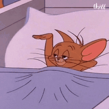 jerry from tom and jerry is laying on a bed with his eyes closed