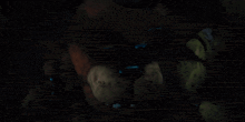 a close up of a cartoon character with glowing eyes and a dark background