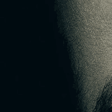 a close up of a person 's face with a black background