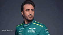 a man is wearing a green and yellow aramco racing suit