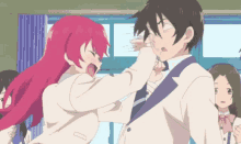 a girl with red hair is slapping a man in a suit