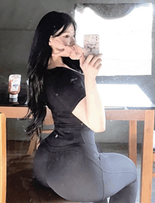 a woman taking a picture of herself in a mirror