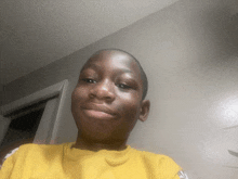 a young boy wearing a yellow shirt with the word lakers on the front