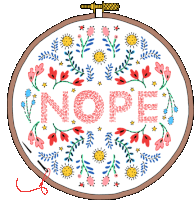 a floral embroidery hoop with the word nope in the center