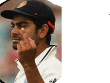 a man wearing a baseball cap and a white shirt is making a middle finger gesture .