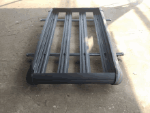 a metal roof rack is sitting on a concrete floor