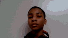 a young boy with his eyes closed wearing headphones around his neck