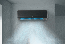 a black air conditioner is hanging on a wall and blowing cool air