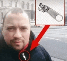 a man is standing in front of a building with a picture of a zipper on his jacket .