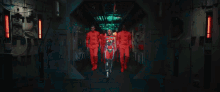 a woman in a futuristic costume is surrounded by men in red uniforms