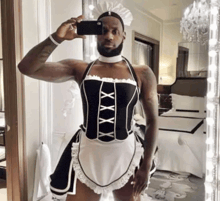 a man in a maid costume takes a selfie