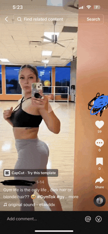 a woman is taking a picture of herself in a gym on her phone