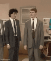a group of men in suits and ties are standing next to each other ..