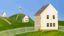 three houses on a hill with a white picket fence in front of them