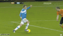 a soccer player in a blue jersey is kicking the ball