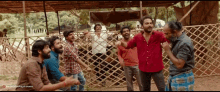 a group of men are standing in front of a wooden fence with a watermark that says ' aa '