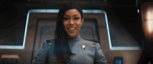 a woman in a space suit is smiling for the camera .