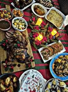 a table topped with plates of food and a napkin that says merry christmas on it