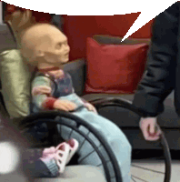 a doll in a wheelchair with a speech bubble behind it