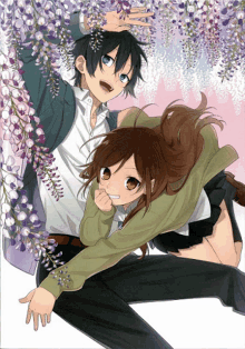 a boy and a girl are standing next to each other in front of purple flowers