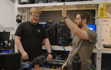 two men giving each other a high five in front of a sign that says quiet please do not disturb