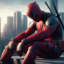 a man in a deadpool costume sits on a ledge with a city in the background