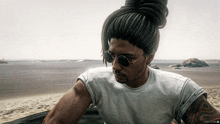 a man with dreadlocks wearing sunglasses and a white t-shirt