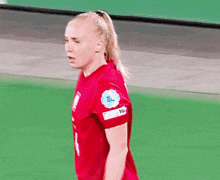 a woman in a red jersey with the number 1 on it
