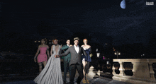 a man in a suit stands in front of a group of women in dresses and a moon behind them