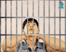 a man in a jail cell with the vlive logo on the bottom