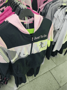 a jacket that says just to do is hanging on a rack