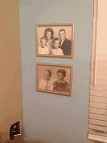 two framed pictures of a family are on a wall