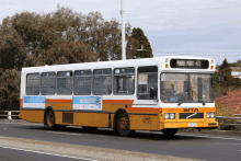 a white and yellow bus with the number 422 on the top