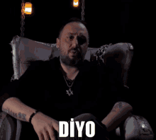 a man with a beard is sitting in a chair with the word diyo written on the bottom