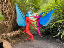 a red and blue origami figure with the word paper on the back