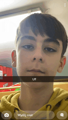 a young boy is taking a selfie with a caption that says " uff "