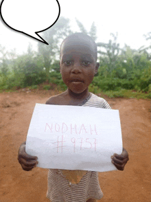 a young girl holds up a sign that says nodhah # 9751